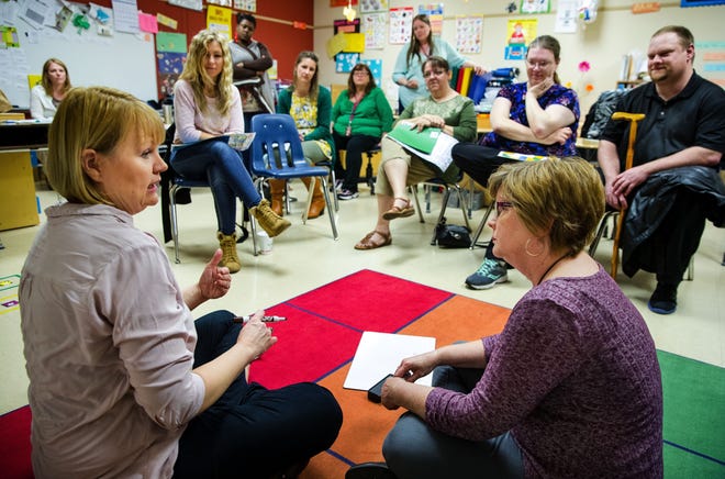 Shelly Phillips, left, and Theresa Szoke, discuss tips on how to play a math game at home for parents of children that attend Matheny-Withrow Elementary School Tuesday, April 4, 2017. [Ted Schurter/The State Journal-Register]