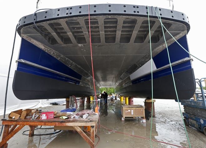 Workers work underneath one of several ferryboats being built for a new fleet of ferries for New York City, at the Metal Shark Shipyard in Franklin, La., on March 30. (AP Photo/Gerald Herbert)