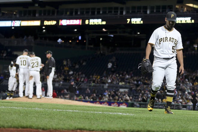 Pirates relief pitcher Antonio Bastardo, right, walks from the pitchers mound after being lifted in the seventh inning against the Reds on Wednesday night in Pittsburgh.