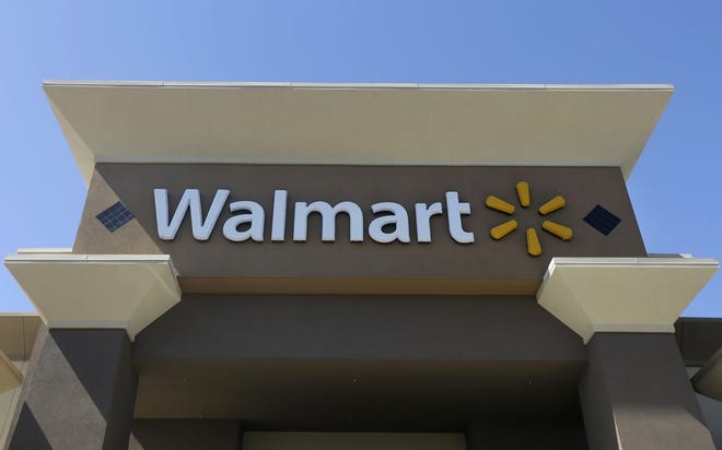 This Sept. 19, 2013, file photo, shows the sign of a Wal-Mart store in San Jose, Calif.