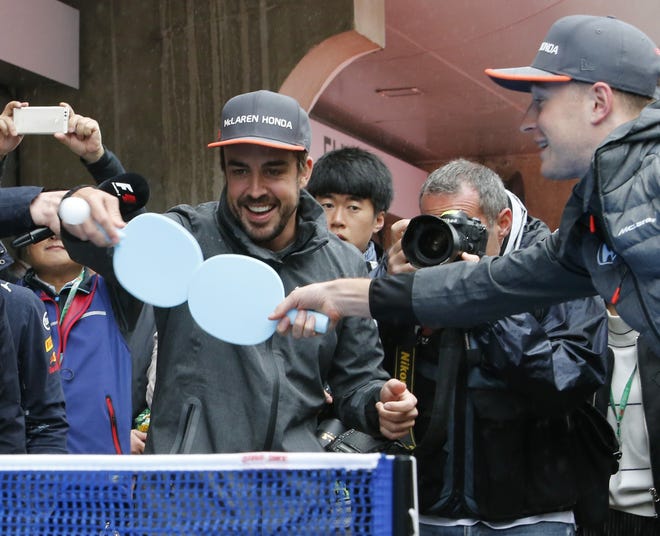 McLaren driver Fernando Alonso, left, of Spain, and Renault driver Nico Hulkenberg, of Germany, play table tennis ahead of the Chinese Formula One Grand Prix at the Shanghai International Circuit in Shanghai, China, on Sunday. Alonso will race in the Indy 500 next month. [AP Photo / Toru Takahashi]