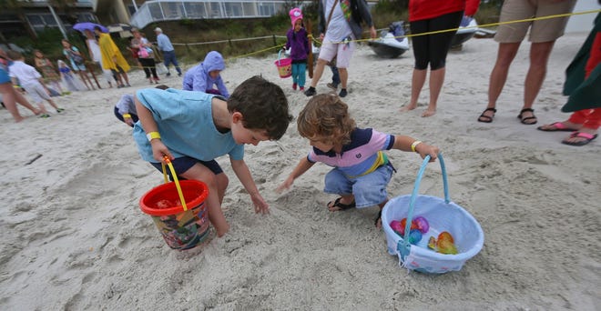 Children hunt for Easter eggs in the sand outside Schooners in Panama City Beach. [CONTRIBUTED PHOTO]