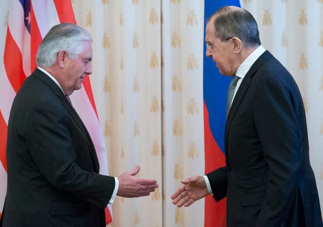 US Secretary of State Rex Tillerson, left, and Russian Foreign Minister Sergey Lavrov shake hands prior to their talks in Moscow, Russia, Wednesday. Tillerson's Moscow talks hinge on new US leverage over Syria. (AP Photo/Alexander Zemlianichenko)