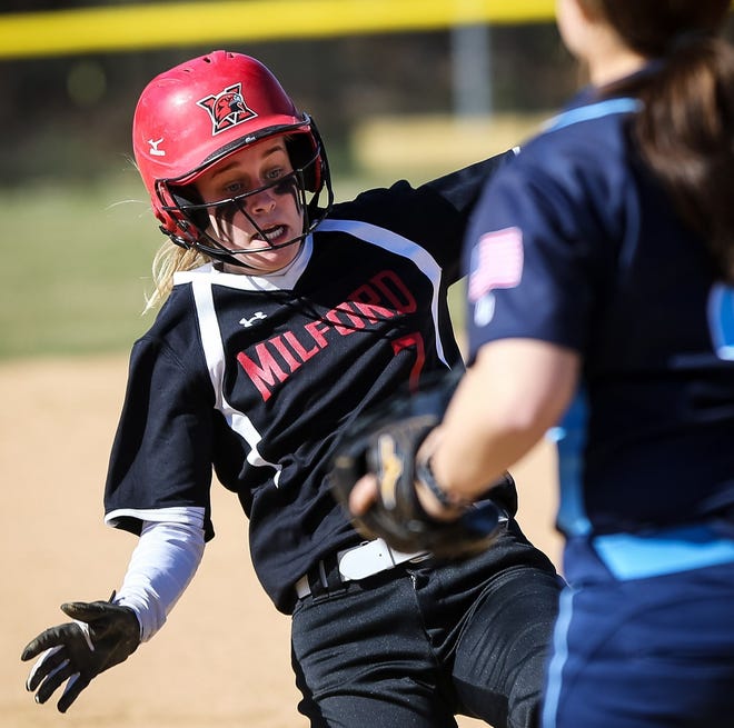 Milford's Kate Irwin slides into third base during the Scarlet Hawks' 6-1 win over Franklin on Thursday.