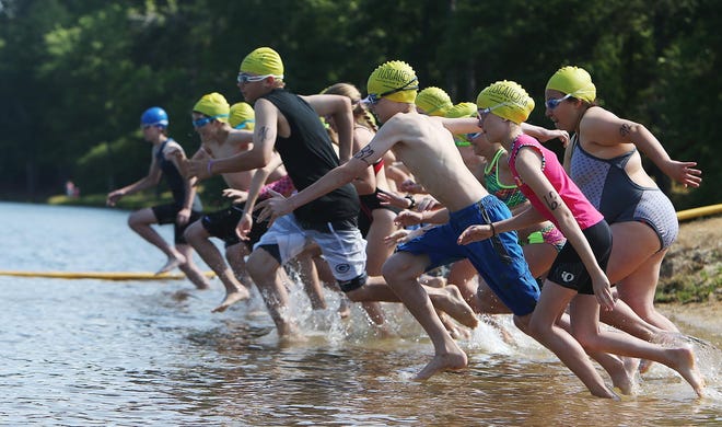 Children run into the water as they participate in the fourth annual Kids Triathlon at Lake Lurleen State Park in Northport. on Saturday May 21, 2016. This year's triathlon is on Saturday, May 20. [Staff photo/Erin Nelson]