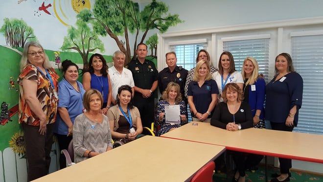 ECCAC President Bill Fletcher, CEO Julie Hurst and staff were presented with a proclamation from Niceville recognizing April as National Child Abuse Month. The proclamation was read by Okaloosa County Undersheriff Steve Harker and Niceville Police Officer Joe Whitfield. [SPECIAL TO THE LOG]