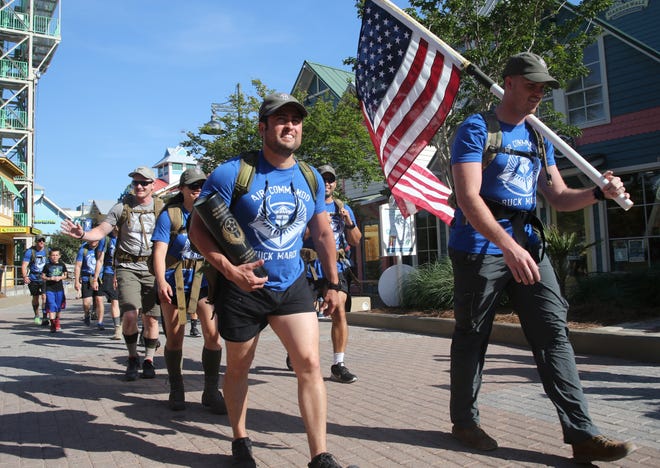 Members of the Air Commandos Ruck March arrive at HarborWalk Village in Destin as they near the end of their journey from Tampa. [MICHAEL SNYDER/DAILY NEWS]