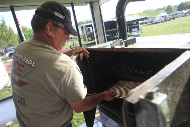 Mark Wolf of team Sue E Pigg does last minute grill prep for the Kings Mountain Fire BBQ cookoff. [Hannah Dunaway/ The Star]