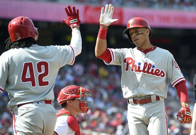 The Phillies' Cesar Hernandez (right) celebrates his two-run home run with Freddy Galvis during the eighth inning against the Nationals on Saturday, April 15, 2017.