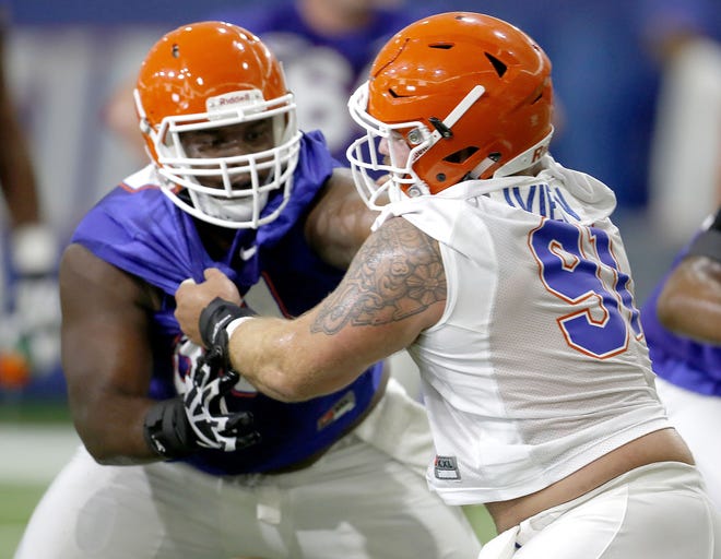 Florida Gators defensive lineman Joey Ivie (91) and offensive lineman T.J. McCoy (59) run a drill during the first of a split practice on Thursday, August 4, 2016 in Gainesville. [MATT STAMEY / GATEHOUSE MEDIA]
