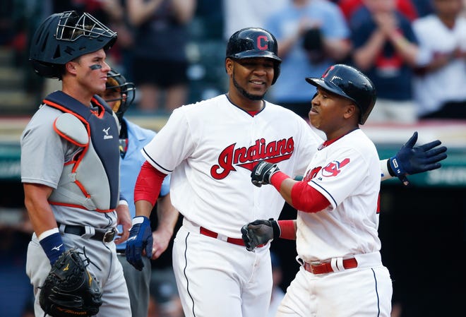 Cleveland Indians' Jose Ramirez, right, gets congratulations from Edwin Encarnacion, center, after hitting a three run home run off Detroit Tigers starting pitcher Anibal Sanchez as catcher James McCann looks on during the eighth inning of a baseball game, Saturday, April 15, 2017, in Cleveland. (AP Photo/Ron Schwane)