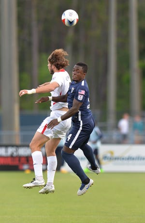 The Deltas’ Tommy Heinemann (9)(left) and the Armada’s Mechack Jerome (4) fight for the ball in the first half. (Bruce Lipsky/Florida Times-Union)