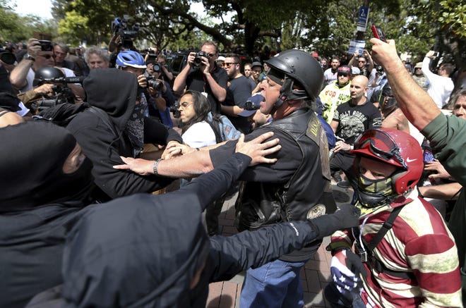 Police intervene as Trump supporters and protesters clash during competing demonstrations at Martin Luther King Jr. Civic Center Park in Berkeley, Calif., on Saturday. [San Jose Mercury News via AP / Anda Chu]
