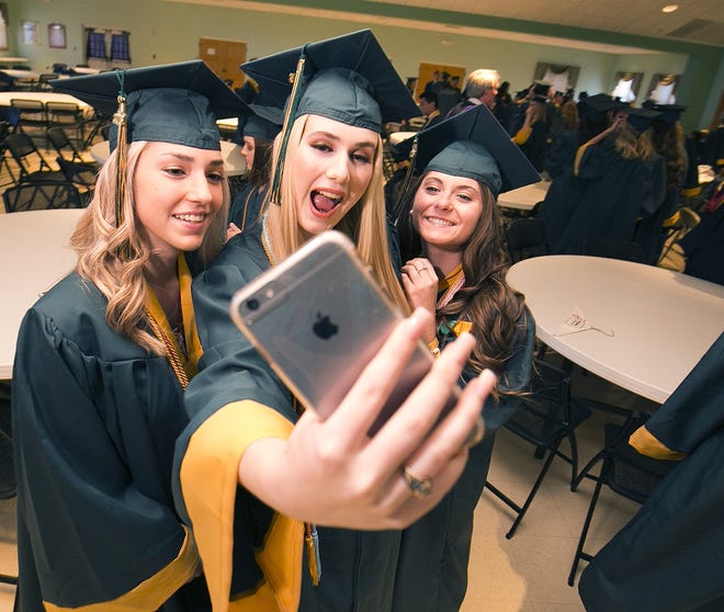 GRADUATIONS: Samantha Niebla, left, Lindsey Predergrast, center and Hallie Fischer, right, take a selife before marching into the St. Mark the Evangelist Roman Catholic Church near The Villages during Trinity Catholic High School's 2016 graduation ceremony. If Marion County had a large civic center, it could host such ceremonies. [Doug Engle/Ocala Star-Banner]2016