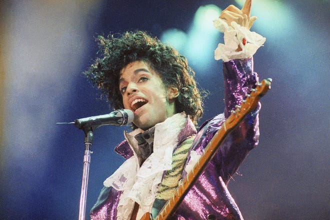 In this Feb. 18, 1985 file photo, Prince performs at the Forum in Inglewood, Calif. A year after Prince died of an accidental drug overdose, his Paisley Park studio complex and home is now a museum and concert venue. Fans can now stream most of his classic albums, and a remastered "Purple Rain" album is due out in June 2017 along with two albums of unreleased music and two concert films from his vault. [AP Photo/Liu Heung Shing, File]