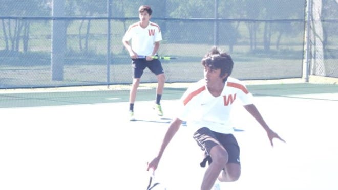 Westwood’s Anirudh Margam attacks the net as doubles partner Gaurav Singh readies for a return. The pair won the District 13-6A boys doubles title. CONTRIBUTED