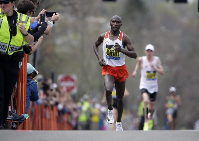 Geoffrey Kirui, of Kenya, leads Galen Rupp, of the United States, and the rest of the field along the course of the 121st Boston Marathon on Monday, April 17, 2017, in Brookline, Mass. (AP Photo/Steven Senne)