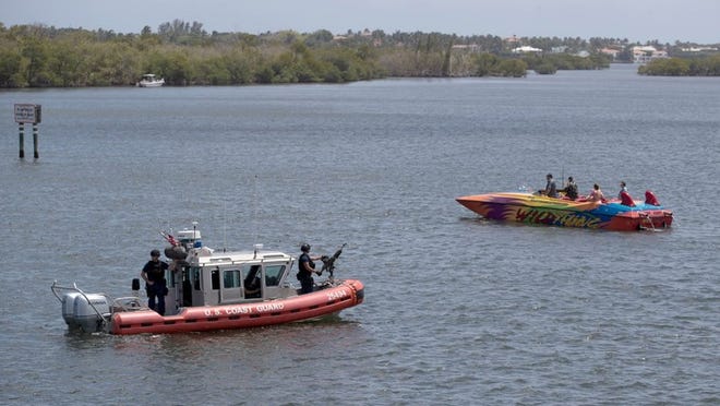 The U.S. Coast Guard patrols the Intracoastal Waterway on Saturday as about 700 protesters cross the bridge on Southern Boulevard. Protesters marched from West Palm Beach to Bingham Island hoping to convince President Donald J. Trump to release his tax returns. Allen Eyestone / Daily News
