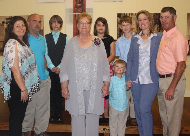 Joining Deborah Matirne (center) on April 5 to celebrate her upcoming retirement from Sacred Heart of Jesus School are Becky Sanchez, Christopher Matirne, Cain Matirne, Carleigh Matirne, Cole Patin (front), Carson Patin, Amy and Tess Patin.
