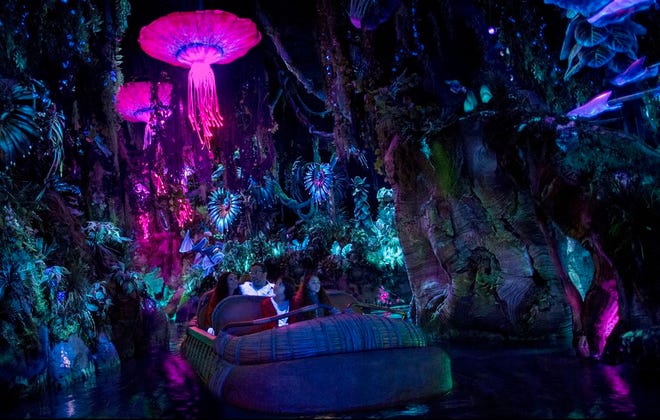 This photo provided by Disney shows guests in the "Na'vi River Journey," part of the new land opening at Walt Disney World's Animal Kingdom in Lake Buena Vista, Fla., on May 27, 2017, called "Pandora - The World of Avatar." The land was inspired by the lush world of Pandora depicted in the movie "Avatar." (Disney via AP)