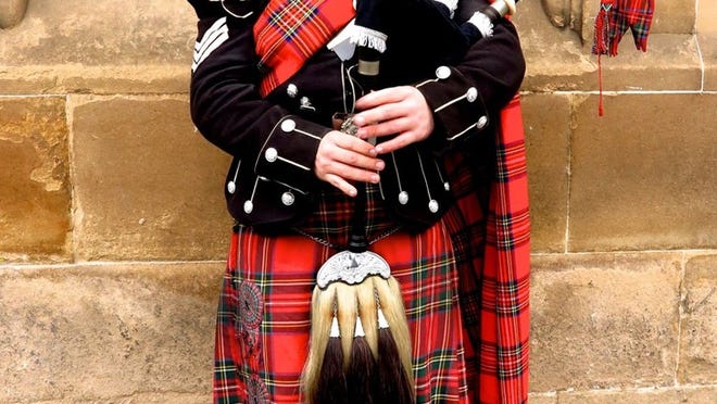 A bagpiper plays along Edinburgh’s Royal Mile. Contributed by Amy Laughinghouse