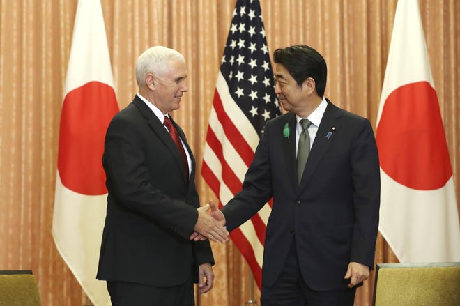 Japanese Prime Minister Shinzo Abe, right, and U.S. Vice President Mike Pence shake hands prior to a luncheon hosted by Abe at the prime minister's official residence in Tokyo, Tuesday, April 18, 2017. Pence arrived in Japan for talks Tuesday expected to focus largely on trade with America's anchor ally in the region. THE ASSOCIATED PRESS