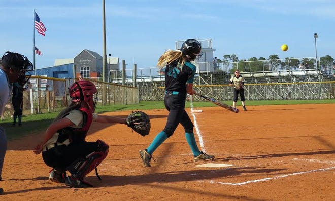 Destin's Braden Runnels cracks one over the centerfield fence in the sixth inning. Destin beat Meigs 6-4 in middle school softball. [LYNN TREADWAY/SPECIAL TO THE LOG]