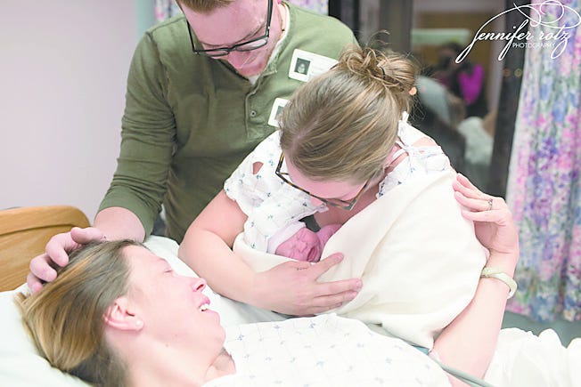 Kelli and Nathan Sopic hold their son Rhett for the first time after he was delivered by surrogate Megan Barkdoll.