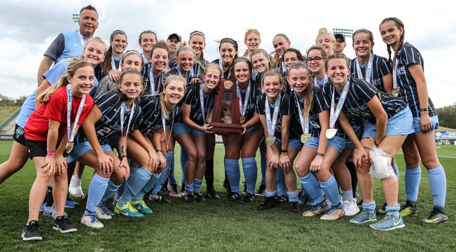 St. Johns Country Day poses with the trophy after winning February's Class 1A state championship. The Spartans finished first in the USA Today national girls soccer rankings, released Tuesday. (For The Florida Times-Union/Gary Lloyd McCullough)