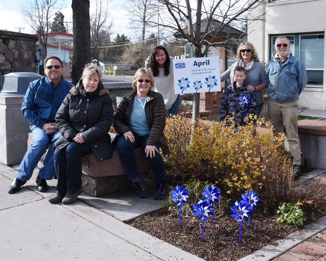 Pinwheels were planted in front of Mount Shasta City Hall on Friday, April 14, 2017 to raise awareness about child abuse prevention. Helping to plant the pinwheels were, left to right, Police Chief Parish Cross, Beautification Committee head Lorie Saunders, Mayor Kathy Morter, Deputy Clerk Kathy Wilson, Siskiyou Community Services Council Program Director Lisa McCauley, Jack Saunders, and, in front, West Lawrence.  By Liz Pyles