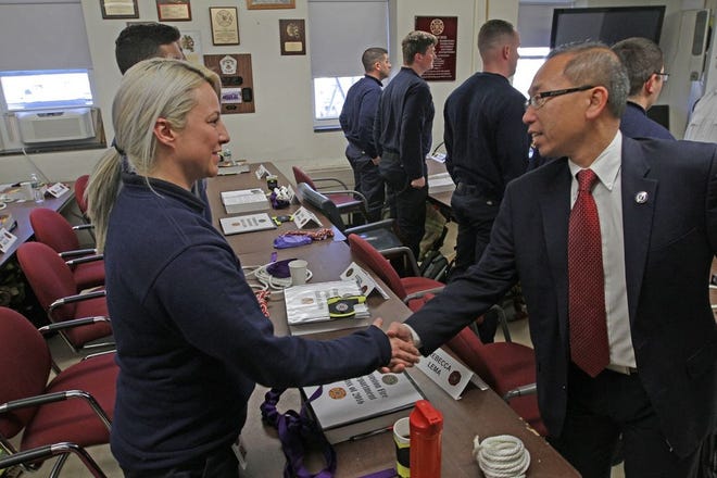 Rebecca Lema is welcomed as a recruit at the Cranston fire academy by Mayor Allan Fung last November. Lema is now a probationary firefighter assigned to Station 2 on Pontiac Avenue.