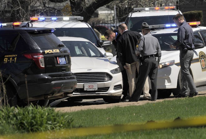 Pennsylvania State Police look over a car as they investigate the scene where Steve Stephens, the suspect in the random killing of a Cleveland retiree posted on Facebook, was found shot dead Tuesday, April 18, 2017, in Erie. Pa. Acting on a tip, Pennsylvania State Police spotted Stephens, 37, in Erie County, in the state's northwest corner, and went after him. After a brief chase, he took his own life, authorities said. GREG WOHLFORD/ERIE TIMES-NEWS