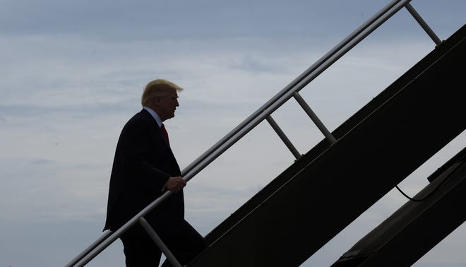 President Donald Trump boards Air Force One in Milwaukee on Tuesday. The White House postponed a meeting Tuesday during which top aides were to have hashed out differences on what to do about the non-binding international deal to reduce climate-warming carbon emissions forged in Paris in December 2015.