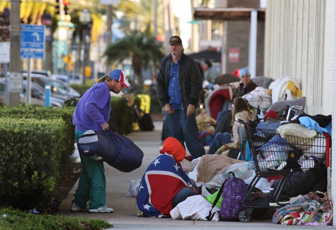 For months last year, homeless people set up camp in front of the Volusia County Tag and Title office on Beach Street in downtown Daytona Beach. Police eventually forced the homeless to move. News-Journal/NIGEL COOK