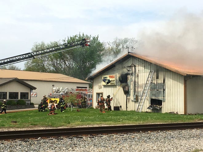 Firefighters from multiple local agencies worked for hours Wednesday to control a blaze at Treu Body Works in Lincoln. [Photo by The Courier]