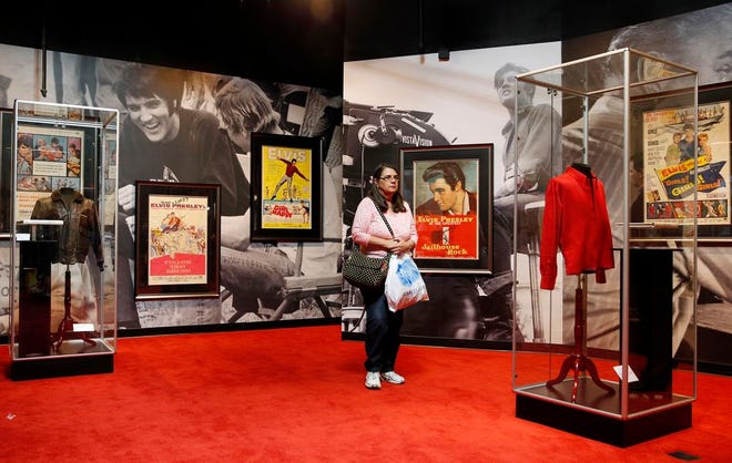 In this April 23, 2015 photo, a woman tours an Elvis exhibition on the first day of "Graceland Presents Elvis: The Exhibition - The Show - The Experience" at the Westgate Las Vegas hotel in Las Vegas. Hundreds of Elvis Presley artifacts and memorabilia are still being held by a Las Vegas casino, a year after the King's estate filed a lawsuit to get those valuables back from a short-lived exhibit. (AP Photo/John Locher, File)