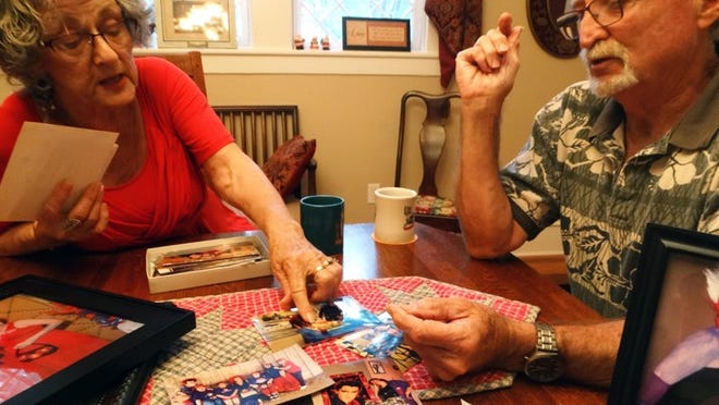 Cathy and Mike Turner look at photos of their friend Deborah Orr, who was killed in the Biloxi bus crash last month. The Turners survived the train wreck with minor injuries and shared their story. MARY HUBER/BASTROP ADVERTISER