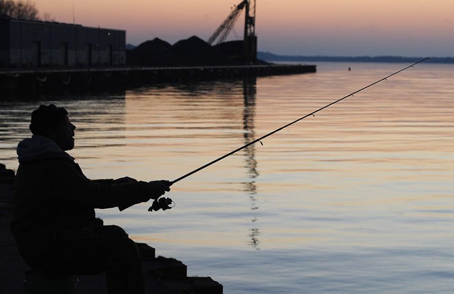 Mark Piechock, of Erie, fishes for perch at the South Pier in 2012. [FILE PHOTO/ERIE TIMES-NEWS]