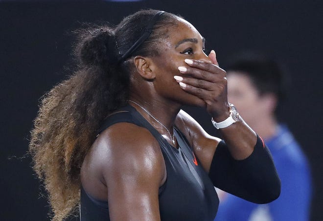 In this Jan. 28, 2017, file photo, Serena Williams covers her face after defeating her sister, Venus, in the women's singles final at the Australian Open tennis championships in Melbourne, Australia. A spokeswoman for Williams says the tennis star is pregnant. THE ASSOCIATED PRESS