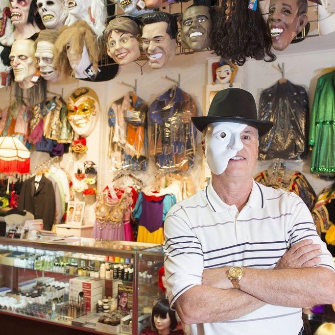 RON JOHNSON/JOURNAL STAR FILE PHOTO Steve Spain owns The Costume Trunk on Main Street. The shop carries specialty costumes and accessories including wigs, hats and masks.