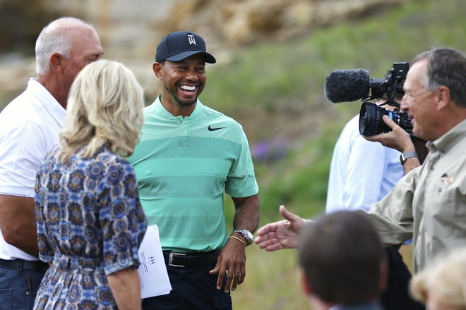 Tiger Woods smiles during a press event for a new golf course designed by Woods, in Hollister, Mo., Tuesday, April 18, 2017. Woods has had a fourth back surgery and likely will miss all three remaining majors this year. THE ASSOCIATED PRESS