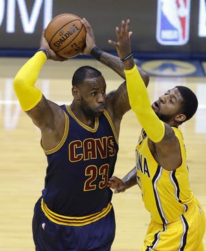 Cleveland Cavaliers' LeBron James keeps the ball from Indiana Pacers' Paul George during the first half in Game 3 of a first-round NBA basketball playoff series, Thursday, April 20, 2017, in Indianapolis. (AP Photo/Darron Cummings)