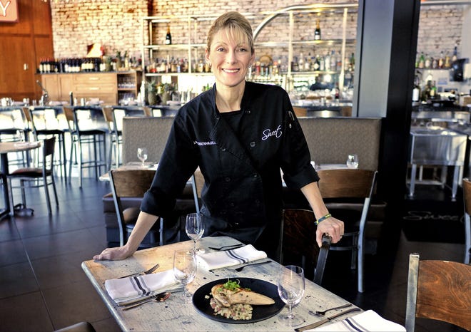 Alina Eisenhauer, chef/owner of Sweet Kitchen & Bar, 72 Shrewsbury St., with a roasted chicken and smoked duck hash dish. [T&G Staff/Steve Lanava]