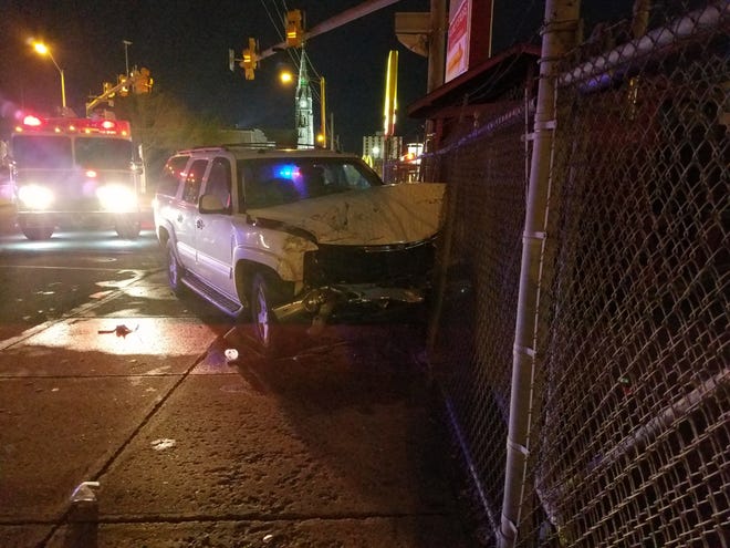 This SUV ended up hitting a chain-link fence around the Salvation Army thift shop at W. 12th and Sassafrass in a crash Friday night. [PAT BYWATER/ERIE TIMES-NEWS]