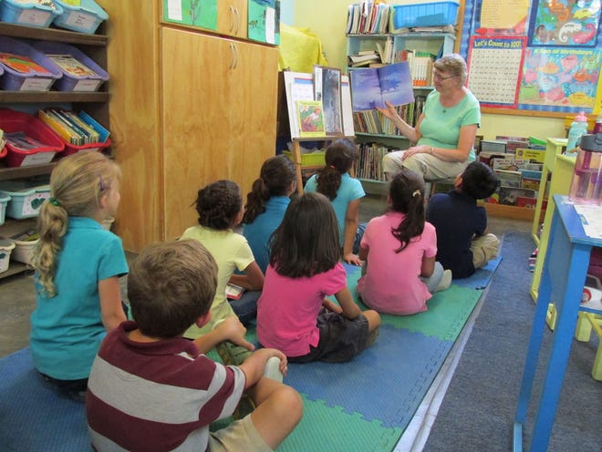 Lorri Scholten reads to missionary children. [Contributed]