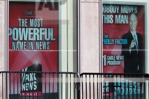 Posters featuring Bill O'Reilly are displayed at the News Corp. headquarters in Midtown Manhattan Wednesday. O'Reilly has lost his job at Fox News Channel after allegations that he sexually harassed women.