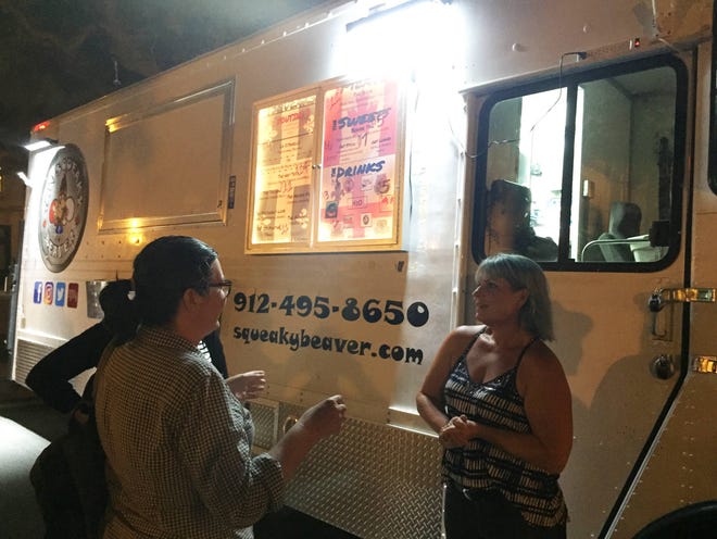 Allison Terrill, right, talks to residents about her food truck, the Squeaky Beaver, on Thursday night. Eric Curl/Savannah Morning News