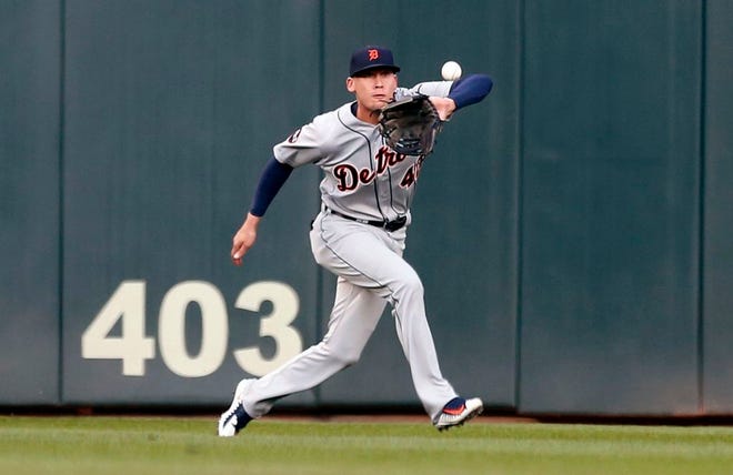 Detroit Tigers center fielder JaCoby Jones eyes the ball hit by Minnesota Twins' Brian Dozier, before making the catch for the out during the first inning of a baseball game Friday, April 21, 2017, in Minneapolis. (AP Photo/Jim Mone)