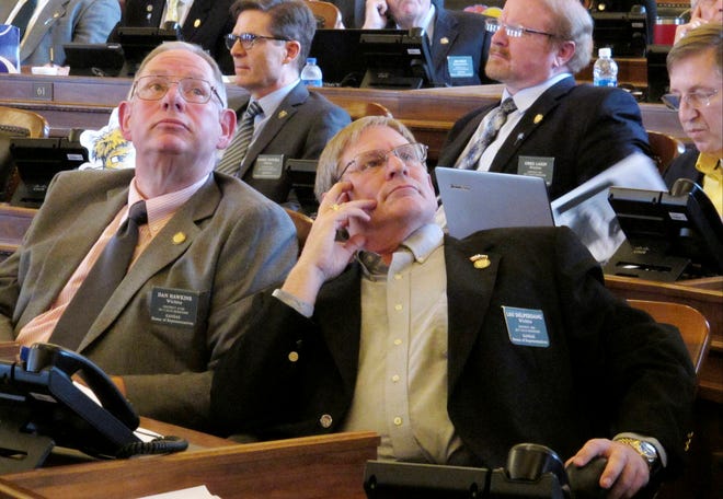 Kansas state Reps. Dan Hawkins, left, and Leo Delperdang, both Wichita Republicans, watch one of the House’s electronic voting boards as Democrats and moderate Republicans fail to override conservative GOP Gov. Sam Brownback’s veto of a bill expanding the state’s Medicaid program under the federal Affordable Care Act on Monday, April 3, 2017, in Topeka. Hawkins and Delperdang are conservatives who opposed the expansion (AP Photo/John Hanna).