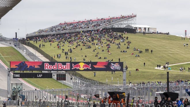 MotoGP fans look on from Turn 1 during qualifying Saturday. Fans who walk to the grand plaza area of Circuit of the Americas will find interactive exhibits, games, music, entertainment and a lot of motorcycles from manufacturers to check out. RICARDO B. BRAZZIELL/AMERICAN-STATESMAN